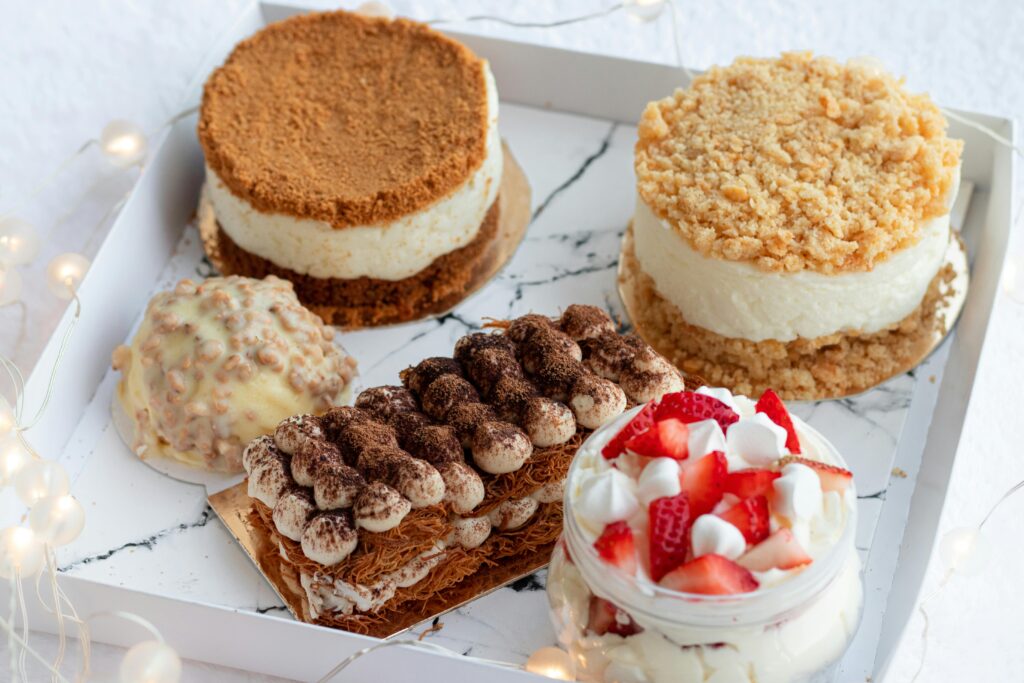 A tempting variety of gourmet cakes and pastries displayed in an elegant box, perfect for dessert lovers.